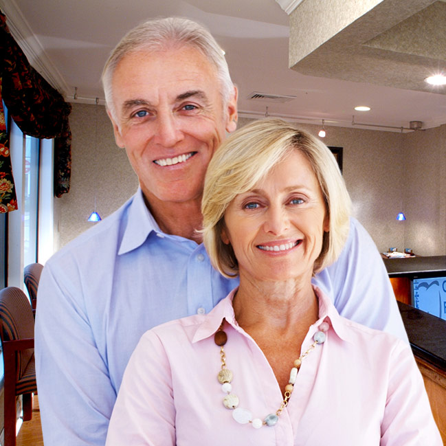 Older couple with whole healthy smiles