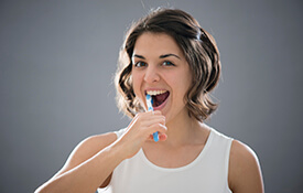 Woman brushing her teeth