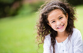 Young girl smiling outdoors